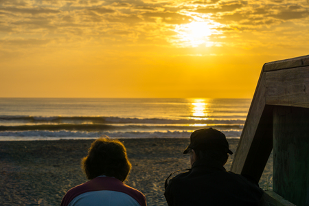 Old Couple Watching the Sunrise Togetherの写真素材