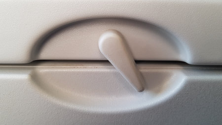 Close-up of a white door handle in a modern airplane.の写真素材