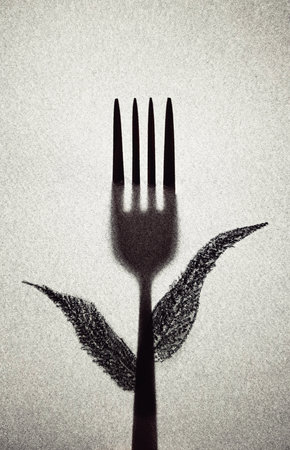 Silhouette of fork and leaves on white background. Toned.の写真素材