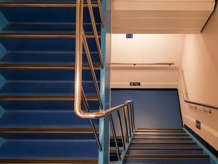 Staircase in a modern building with blue walls and stairs.
