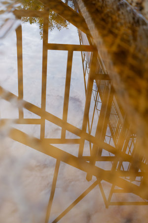 Golden geometric reflections on water surface with abstract shapes and patterns, artistic design, modern minimal photography for backgrounds, textures, creativity.の写真素材