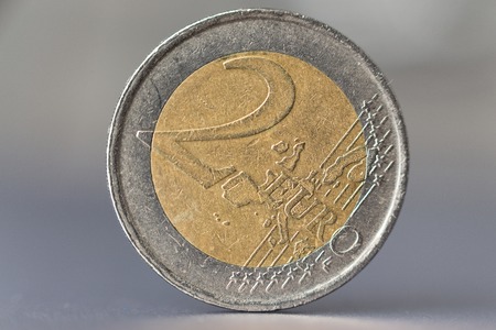 Two euro coin with a smoothly blurred grey backgroundの写真素材
