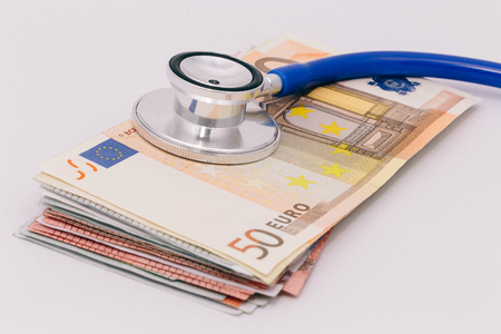 The head of a stethoscope on a stack of fifty euro notesの写真素材