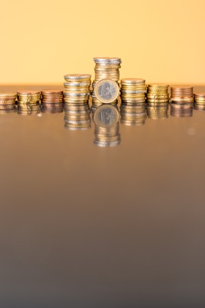 Stacks of coins with a golden glowの写真素材