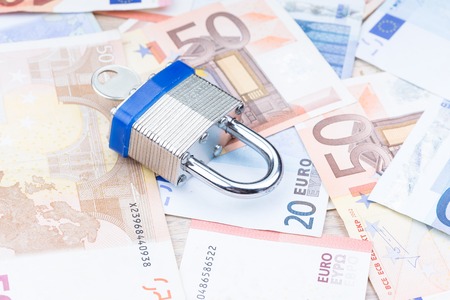Padlock on a layer of bank notes