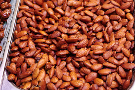 Roasted and salted almonds with skin. Tasty and delicious very toasted almonds.