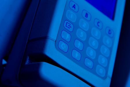 A time clock is mounted to a wallの写真素材