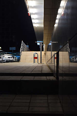 Cars in the parking lot near the shopping center. Entrance steps. reflection. night city.の写真素材