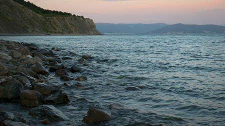Pink sunset on the Black Sea coast. A late summer evening sinks ashore. beautiful scenery. Russia.