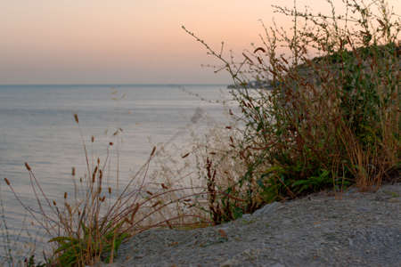 Beautiful seascape. Rocky seashore. Sunset. Pink sky. Black Sea. Russia.の写真素材