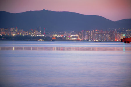 Summer warm sea evening, the sun sets over the horizon, coloring the rocky seashore with magical light, seascape, blurred background, Black Sea, Russiaの写真素材