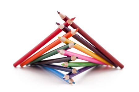 A pile of colored pencils on white background.