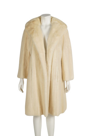 Fur coat on a mannequin. Isolated on white backgroundの写真素材