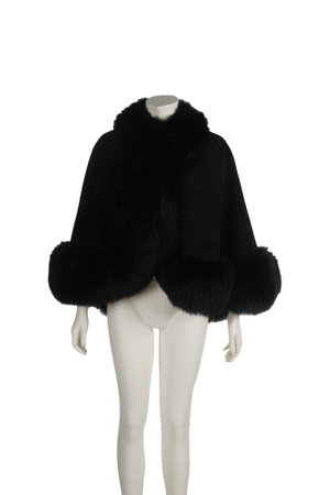 Black fur coat on mannequin. Isolated on white backgroundの写真素材