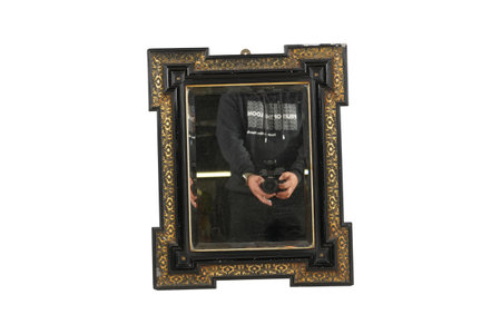 A picture of a man looking through a mirror isolated on white backgroundの写真素材