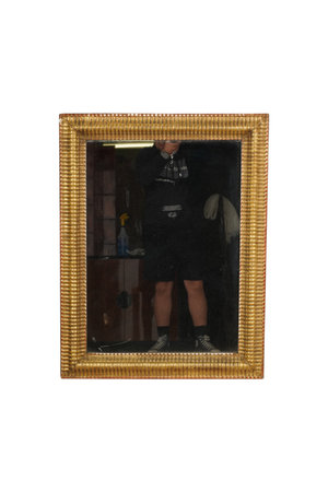 Man looking through a mirror. Isolated on a white background.の写真素材