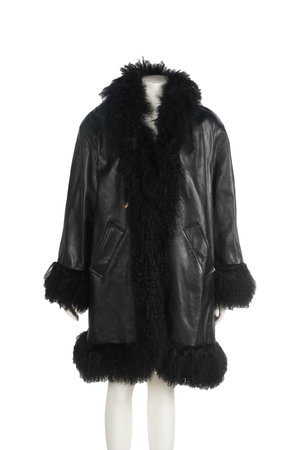 Female mannequin dressed in black leather jacket and fur collar. Isolated on white background.の写真素材