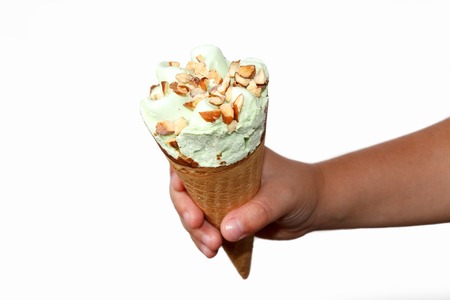 Child hand holding ice cream isolated on white backgroundの写真素材