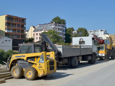 Construction machinery stands at the side of the road at the site of road construction worksのeditorial素材