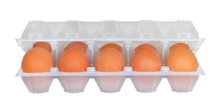 Raw brown chicken eggs in half-opened white semitransparent plastic packaging isolated on white backgroundの写真素材