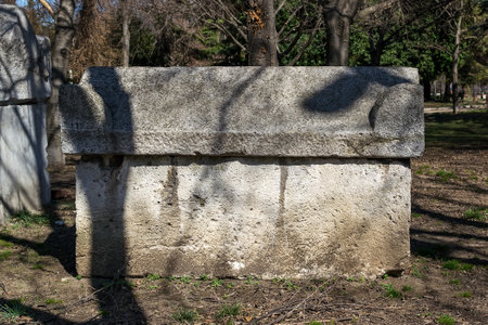 Ancient stone sarcophagus in the park. Antique stone tombs are located in a public park next to the Archaeological Museum in Varna. Tourist attractions and landmarks on a sunny day.のeditorial素材