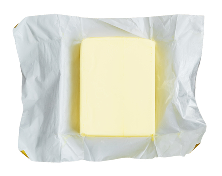 Just opened package of fresh yellow butter isolated on white background. Organic dairy products and food ingredient. Top view.の写真素材