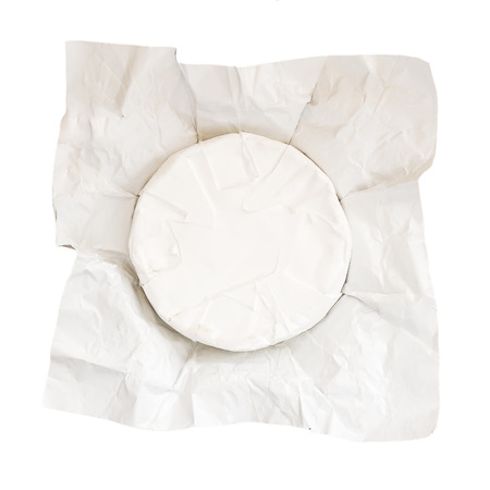 Open paper package of whole head of camembert isolated on white background. Soft cheese covered with...