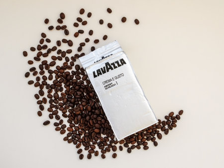 Varna, Bulgaria, September 28, 2019. Ground coffee Lavazza Crema E Gusto in a silver pack  and coffee beans on a white table. Coffee in a circular economical packaging. Top view.のeditorial素材