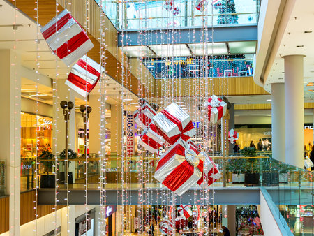Varna, Bulgaria, December 20, 2019. Interior of the Grand Mall shopping center festively lit and decorated with shiny garlands and large gift boxes. Holiday shopping.のeditorial素材