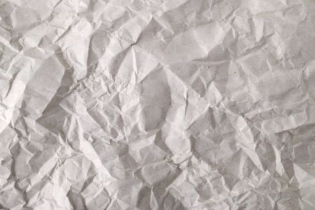 Texture of crumpled gray wrapping paper. Background of creased package paper. Empty grey crumpled paper. Copy space. Top view.の写真素材