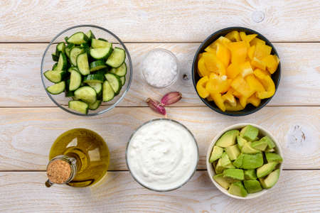Fresh cold cucumber soup puree in a glass bowl isolated on white background. Raw food diet soup from...