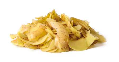 Heap of fresh yellow potato peels isolated on white background. Cook boiled potatoes at home. Household biodegradable waste. Front view.の写真素材