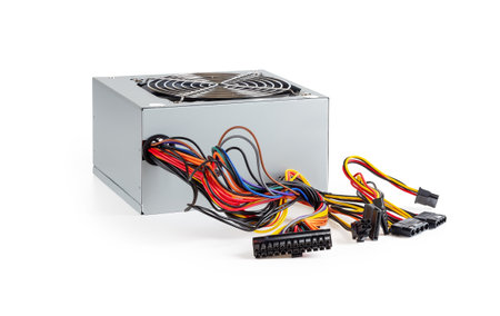 New power supply unit with a lot of colorful wires and connectors isolated on white background....