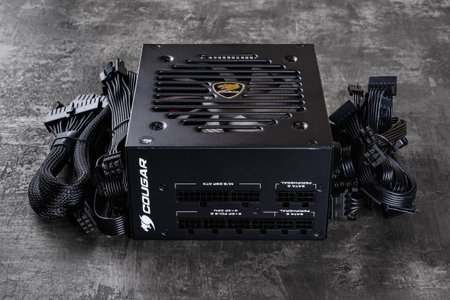 Varna, Bulgaria, January 11, 2021. Cougar GEX 80 Plus Gold certified PSU and set of power cords on a...