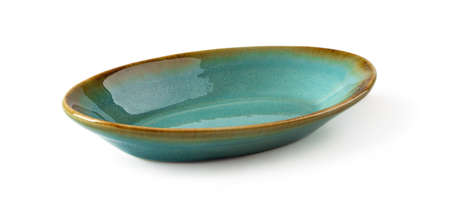 Side view of oblong turquoise ceramic plate isolated on a white background. Empty crockery for food design. Modern stylish dishes and tableware made of clay, ceramics and porcelain. Close-up.の写真素材
