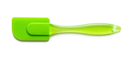 Green cooking silicone spatula isolated on white backgrounds. New rubber spatula with plastic handle for confectionery, bakery and pastry. Heat resistant kitchenware tool device. Top view.の写真素材