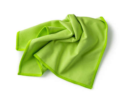 Crumpled green microfiber cloth isolated on white background. Soft microfiber napkin for cleaning...