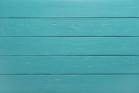 Texture of wooden planks surface of turquoise color. Background of green blue horizontal wood boards. Pattern of slightly scratched rustic table top. Full frame design element. Top view.の写真素材