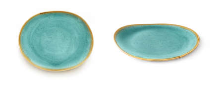 Oval porcelain plate isolated on a white background. Front view of turquoise tableware with yellow border. Top view on empty dish for food design. Modern colorful crockery cutout. Closeup.の写真素材