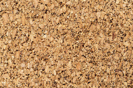 Brown cork texture macro. Background of corkboard surface for paper notes and memo stickers. Grainy wood material of the cork oak bark. Cork board concept. Full frame. Closeup.の写真素材