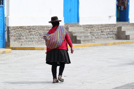 Peruvian woman in traditional costume in the village Paucartambo at Cusco, Peru
