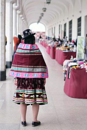 Peruvian woman in traditional costume in the old town of Arequipa.