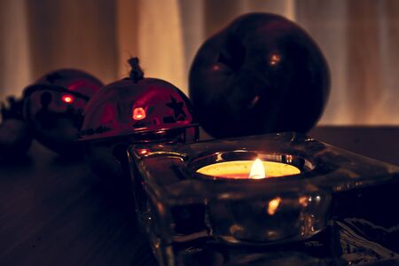 Christmas candles, red apples, cones and spices on rustic wooden background. Close up, selective focusの写真素材