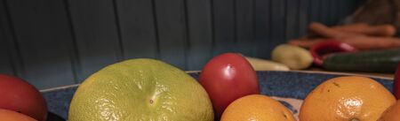 Citrus fruits on wooden background. Lime, lemon, tangerine on wooden table and blue background.の写真素材
