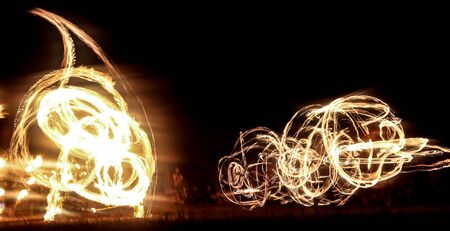 Fire show and a lot of bright sparks in the nightの写真素材