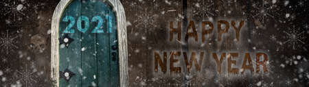 Happy new year 2021 card design. Entrance to the new year. Merry christmas and happy new year 2021. Holiday glowing illustration. Small wooden door in a wooden house. Magic door in a tree.の写真素材