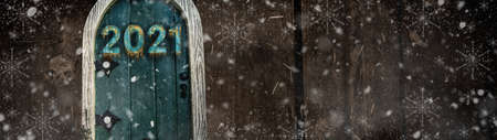Happy new year 2021 card design. Entrance to the new year. Mery christmas and happy new year 2021. Holiday glowing illustration. Small wooden door in a wooden house. Magic door in a tree.の写真素材