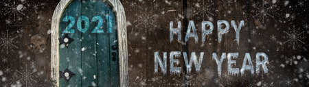 Happy new year 2021 card design. Entrance to the new year. Merry christmas and happy new year 2021. Holiday glowing illustration. Small wooden door in a wooden house. Magic door in a tree.の写真素材