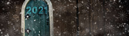 Happy new year 2021 card design. Entrance to the new year. Mery christmas and happy new year 2021. Holiday glowing illustration. Small wooden door in a wooden house. Magic door in a tree.の写真素材