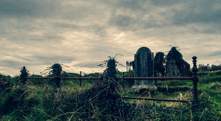 Ireland celtic cross at medieval church cemetery Old spooky cemetery. Haunted cemetery. Scary place. Old gravesの写真素材